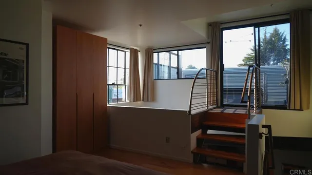 a view of a balcony with wooden floor and stairs