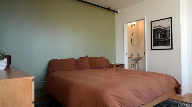 a bedroom with a bed and cabinets