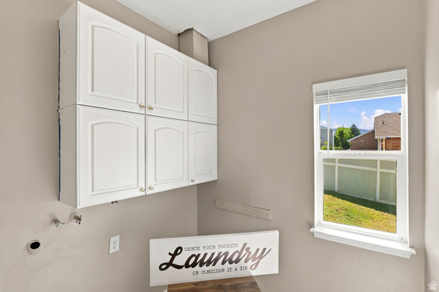 926 Ibis Way Draper, UT 84020 - Photo 20 of 41 Laundry room with laundry chute going into the cabinet on the right.