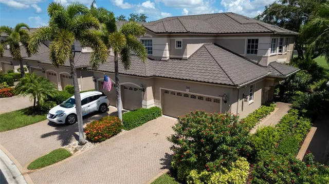 a aerial view of a house with table and chairs under an umbrella