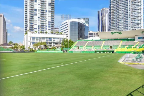 a house with a yard and palm trees