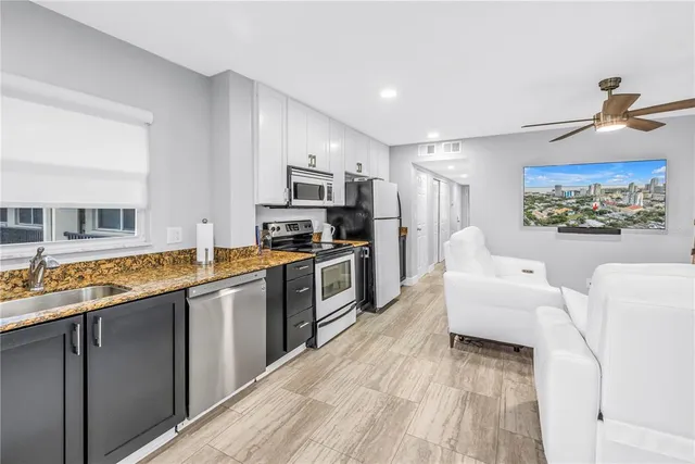 a kitchen with stainless steel appliances granite countertop a stove and a sink