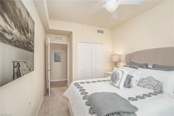 a bedroom with a bed and a mirror