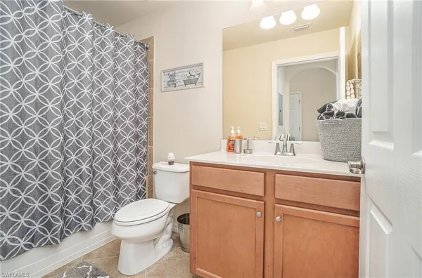 a bathroom with a sink mirror vanity and toilet