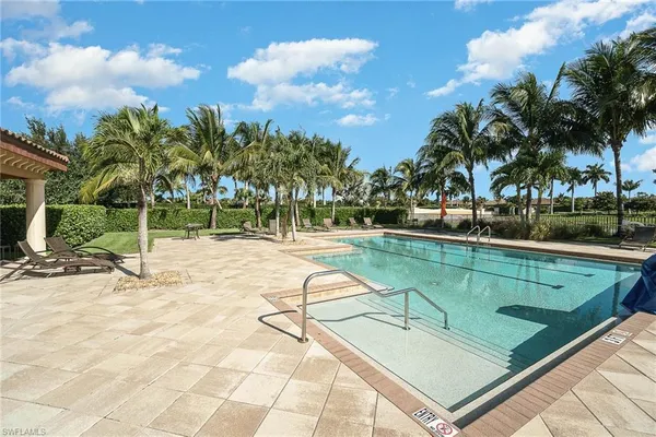 a swimming pool with outdoor seating and yard