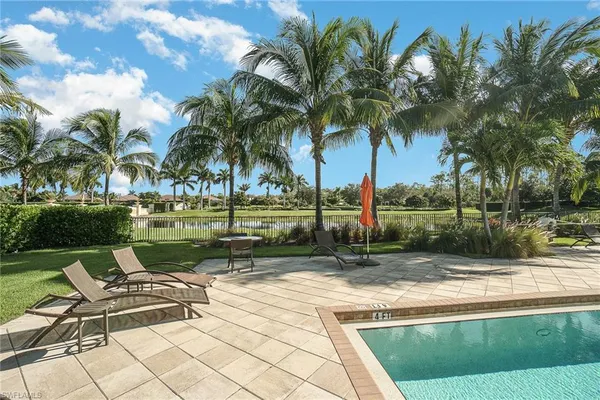 a view of a yard with a swimming pool and sitting area