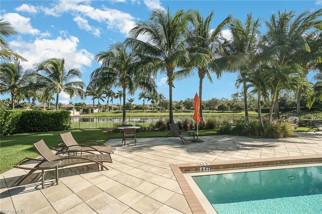 9731 Acqua Court, Unit 533 Naples, FL 34113 - Photo 17 of 22 a view of a yard with a swimming pool and sitting area
