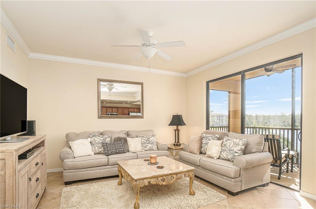9731 Acqua Court, Unit 533 Naples, FL 34113 - Photo 3 of 22 a living room with furniture and a flat screen tv