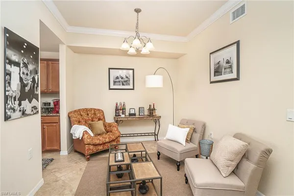 a living room with furniture a chandelier and a couch