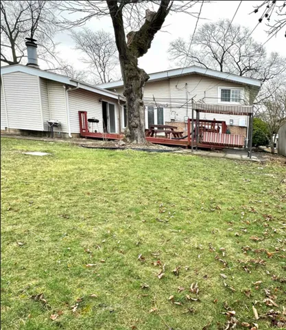 a view of a house with a yard patio and sitting area
