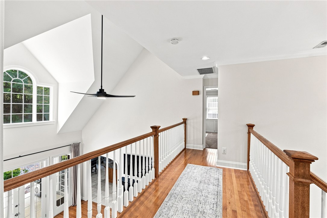 320 Watson Road Easley, SC 29642 - Photo 28 of 50 An upper-level hallway overlooks the main living space through a classic wooden balustrade.