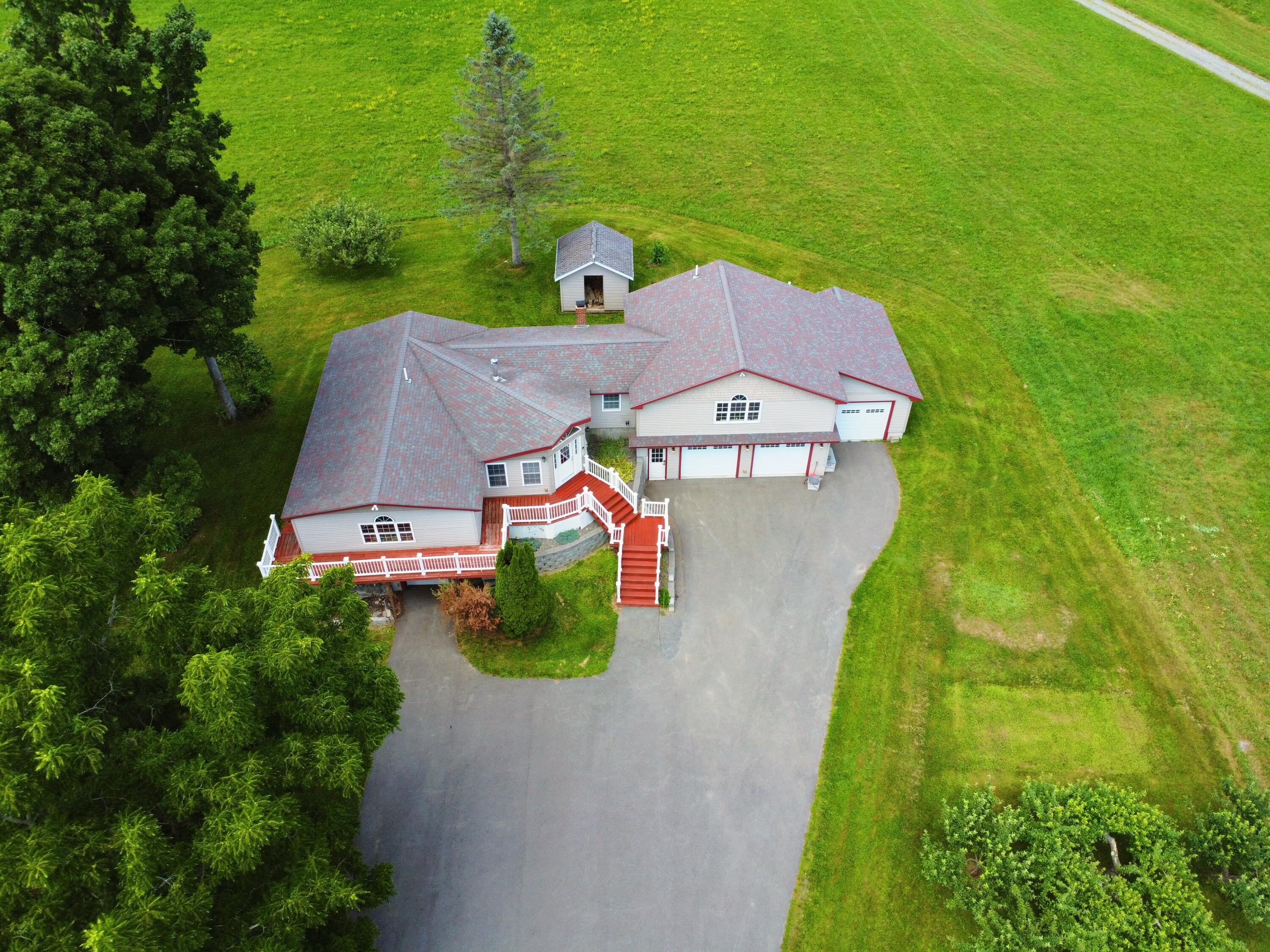 356 Range Road Dover Foxcroft, ME 04426 - Photo 16 of 58 FromMidDrivewayLookingDownOnHouse_DJI_03