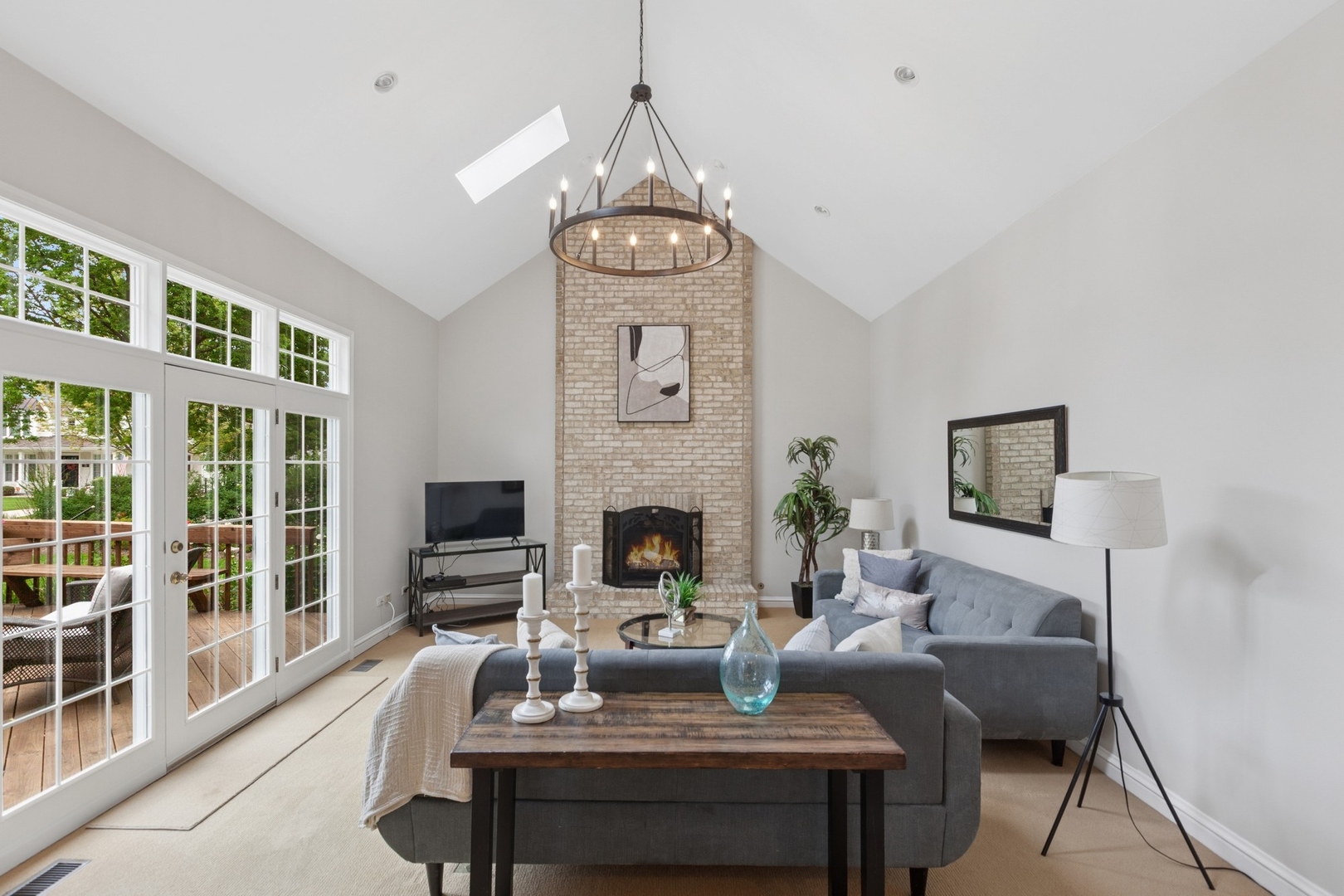 415 Fuller Road Hinsdale, IL 60521 - Photo 13 of 39 a living room with furniture a fireplace and a flat screen tv