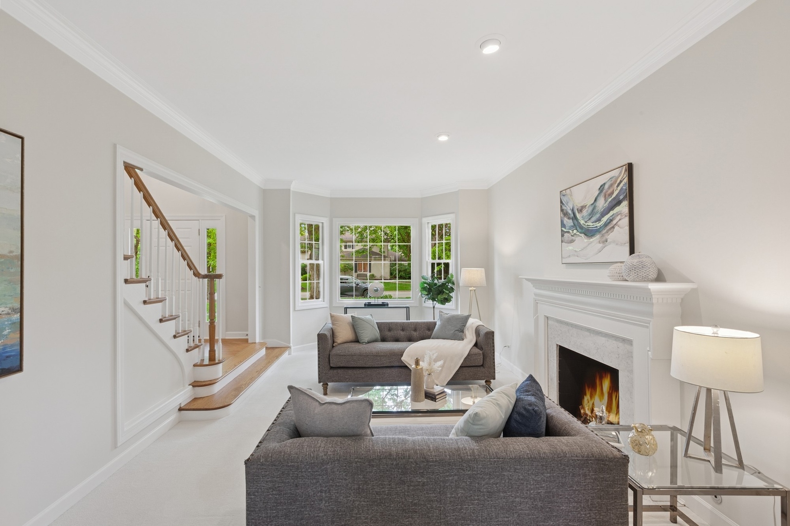 415 Fuller Road Hinsdale, IL 60521 - Photo 5 of 39 a living room with furniture a fireplace and a large mirror next to a window