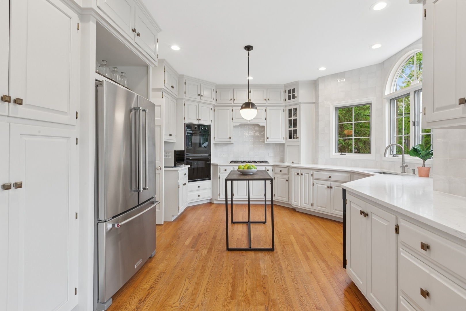 415 Fuller Road Hinsdale, IL 60521 - Photo 10 of 39 a kitchen with stainless steel appliances a refrigerator sink and wooden floor