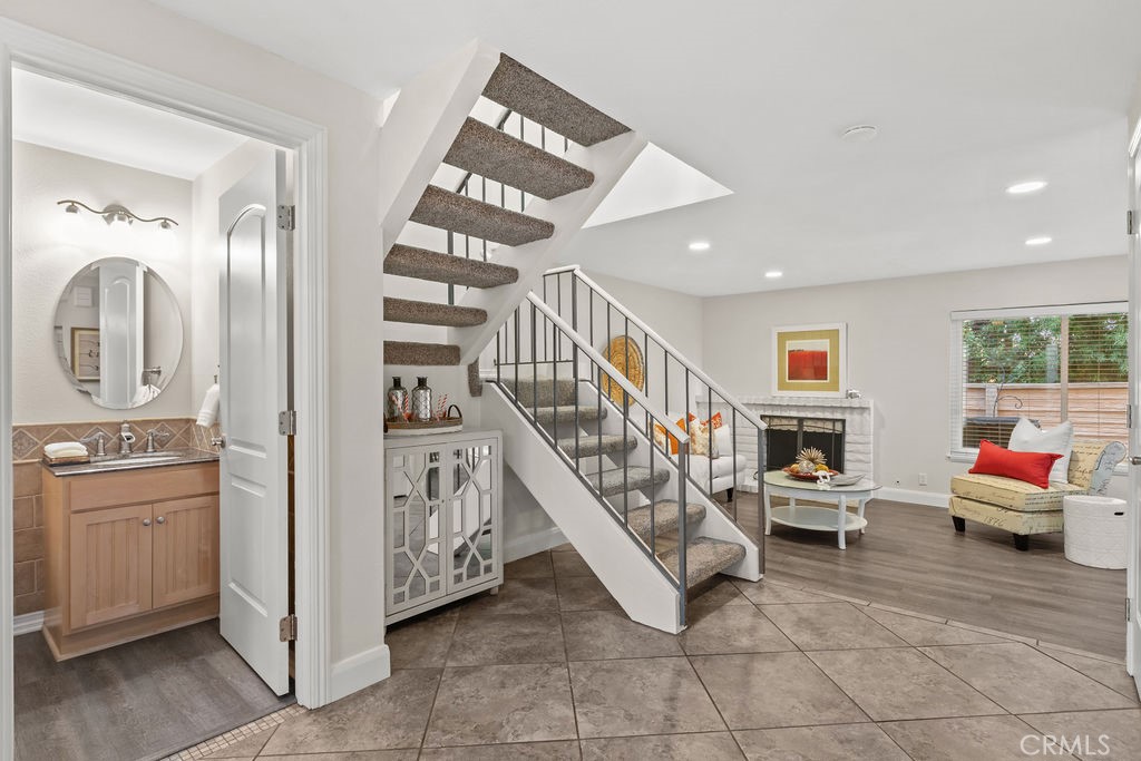 a living room with furniture and stairs