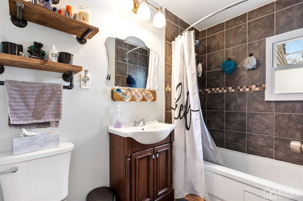 44 Ashley Road Edison, NJ 08817 - Photo 8 of 26 a bathroom with a sink a toilet and shower