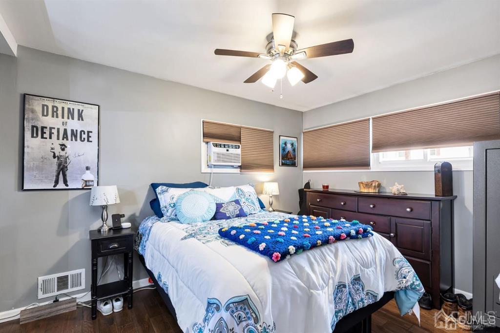 44 Ashley Road Edison, NJ 08817 - Photo 10 of 26 a bedroom with a large bed and a chandelier