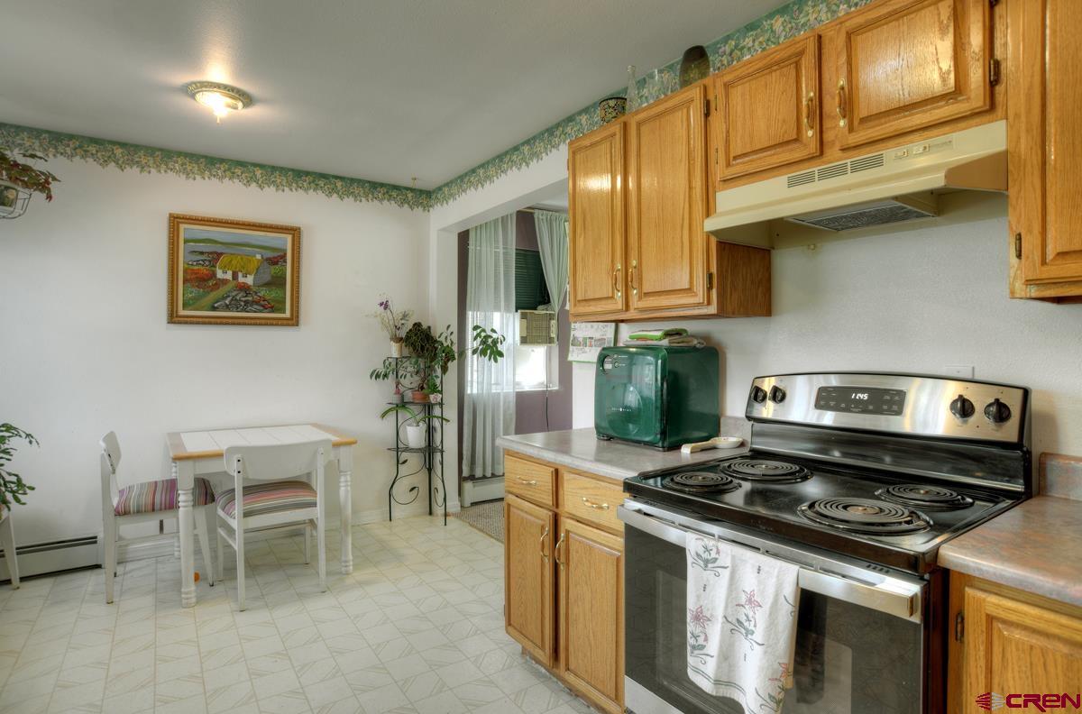 229 Jenkins Ranch Road, Unit D Durango, CO 81301 - Photo 8 of 27 a kitchen with a stove and a refrigerator