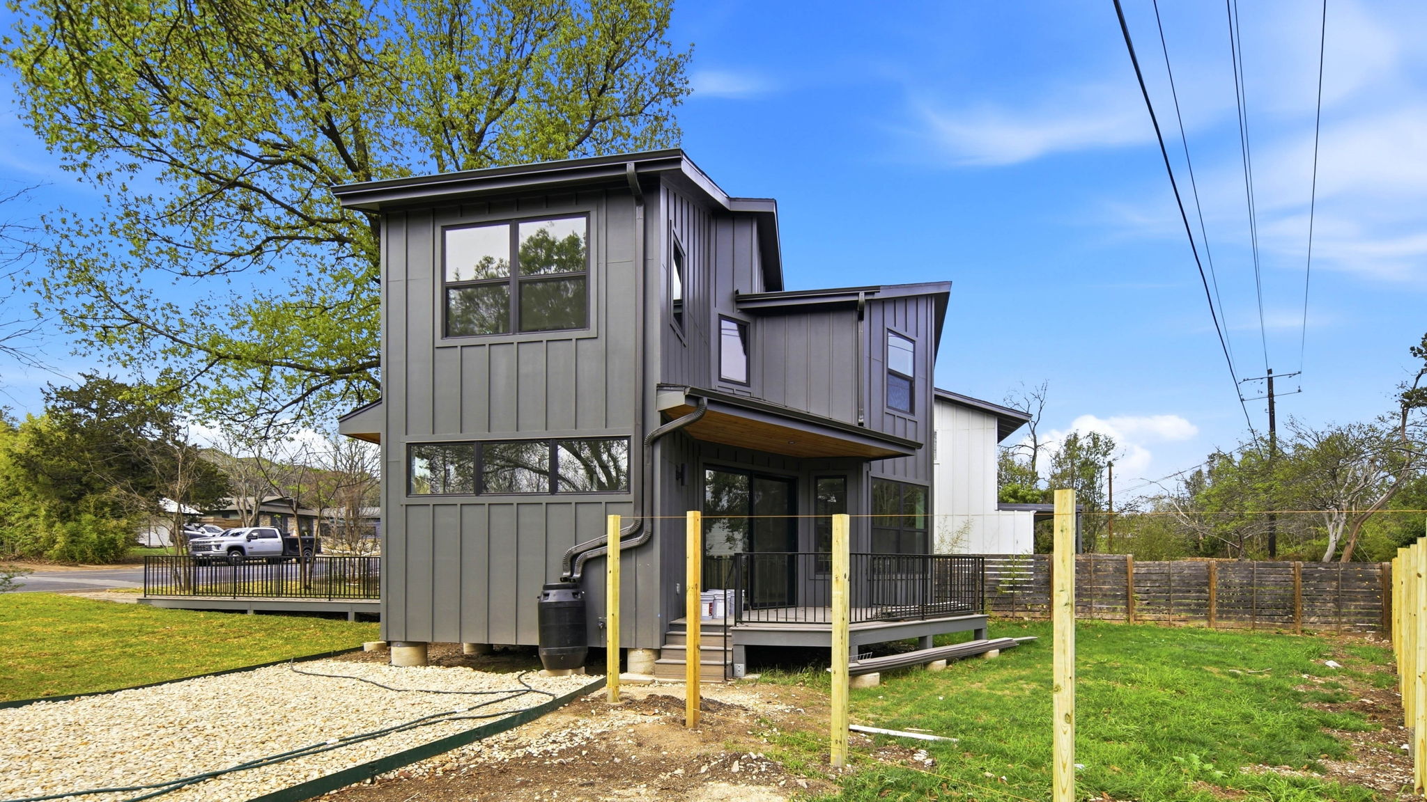 300 Lightsey Road, Unit 2 Austin, TX 78704 - Photo 28 of 28 Rear view of property with a wooden deck, board and batten siding, and a fenced backyard
