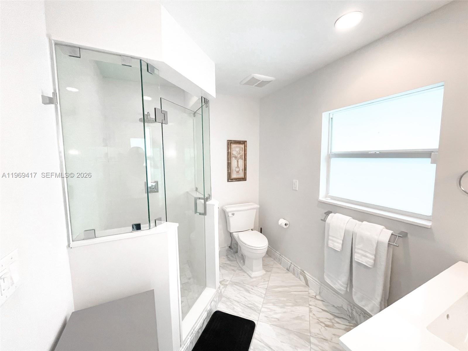 2932 Northeast 36th Street Lighthouse Point, FL 33064 - Photo 13 of 34 a bathroom with a sink a toilet and a shower