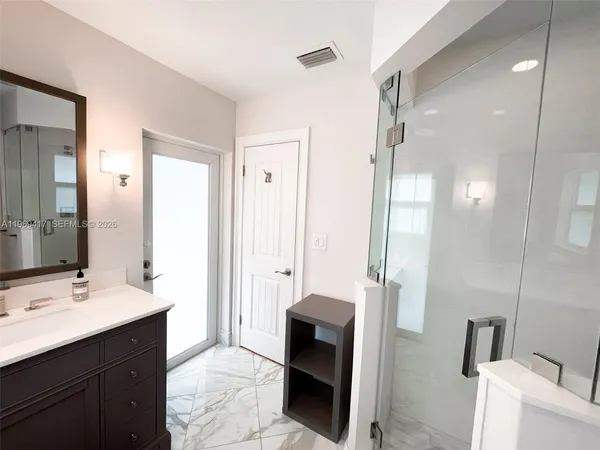 a bathroom with a double vanity sink a toilet and a mirror