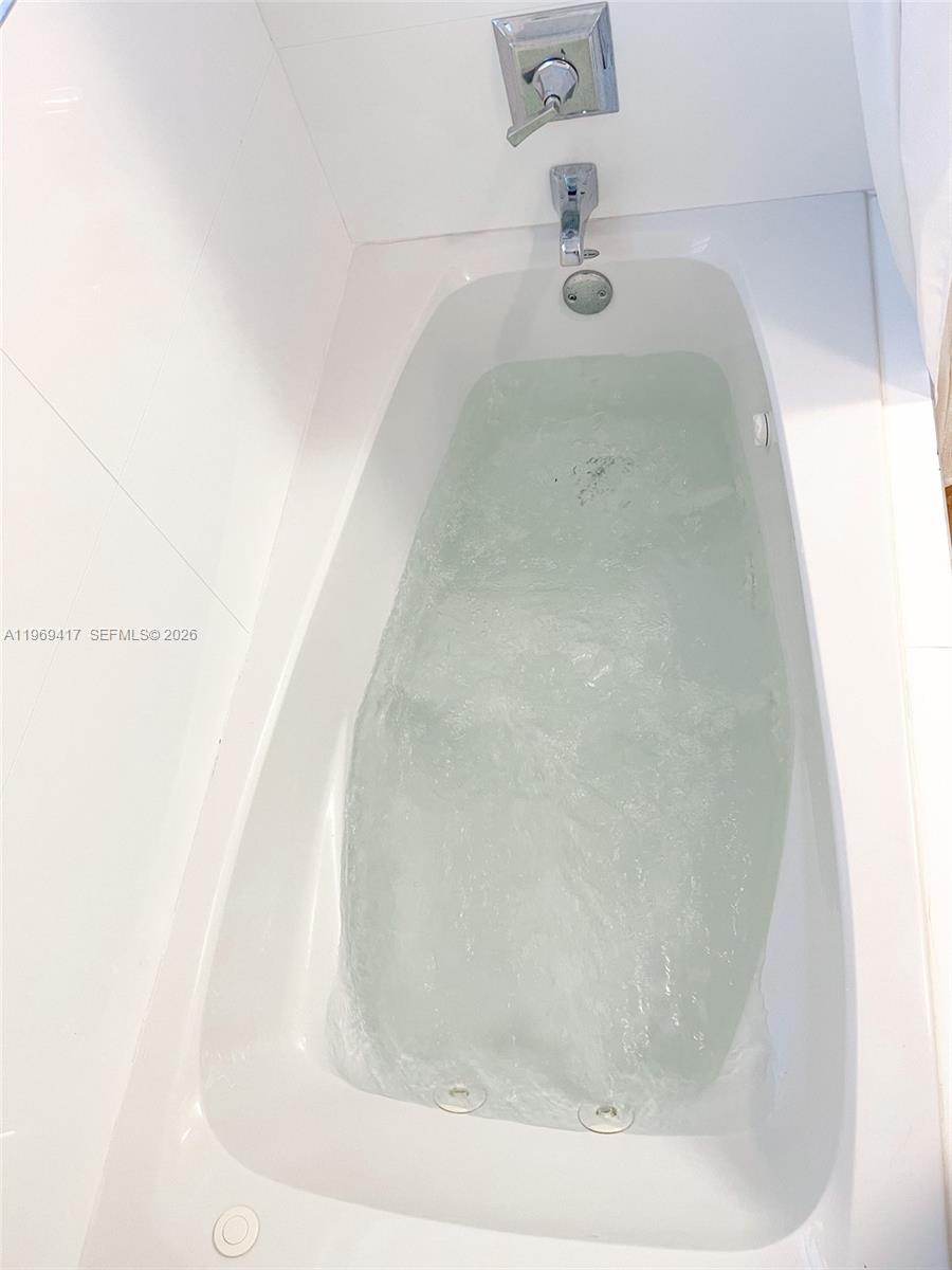 2932 Northeast 36th Street Lighthouse Point, FL 33064 - Photo 16 of 34 a view of a bathtub in a bathroom