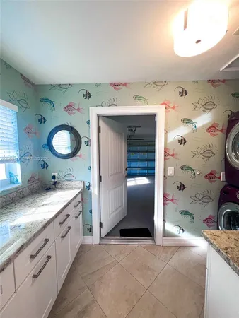 a spacious bathroom with a granite countertop sink and a mirror