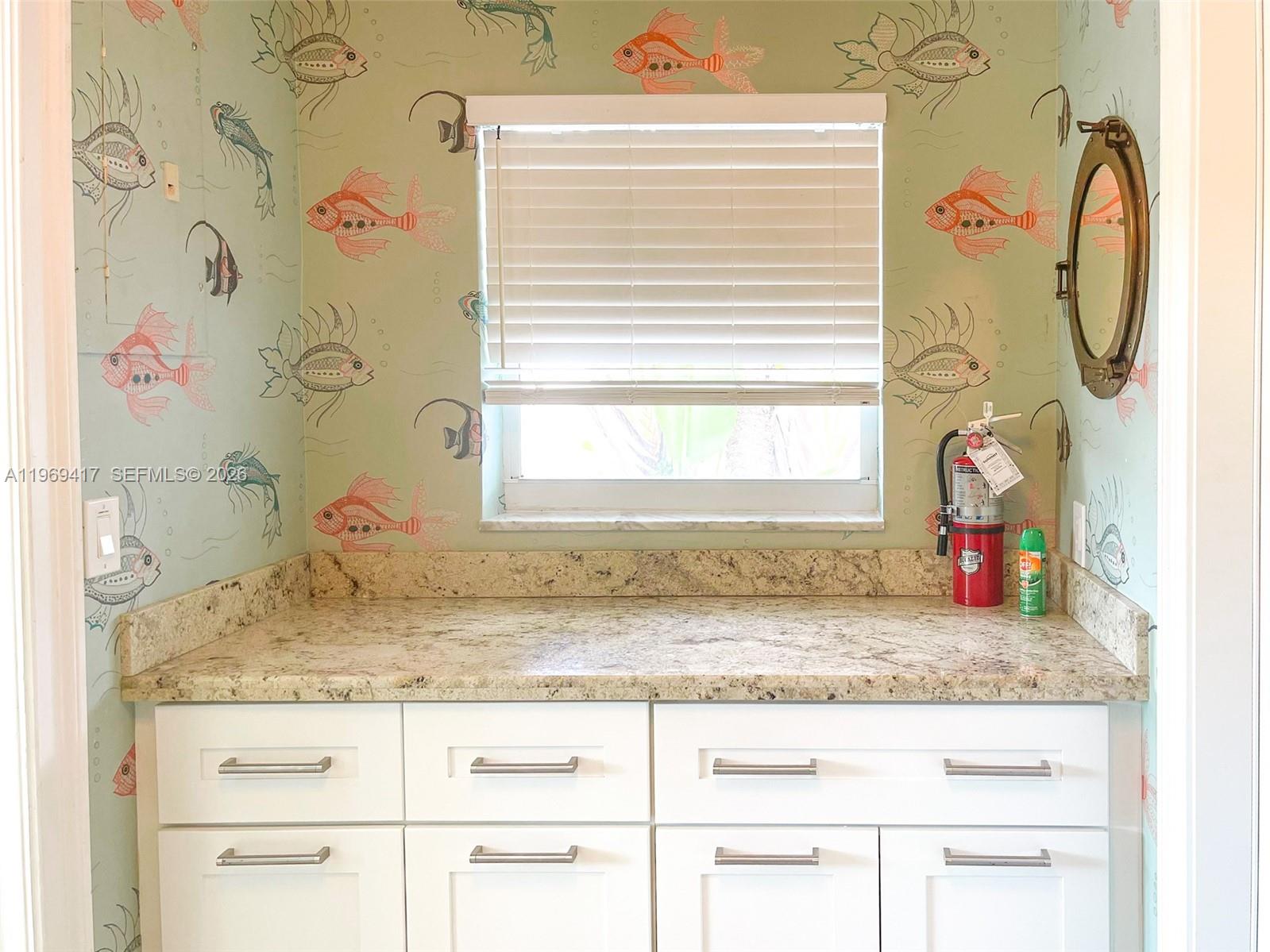 2932 Northeast 36th Street Lighthouse Point, FL 33064 - Photo 19 of 34 a bathroom with a granite countertop sink and a mirror