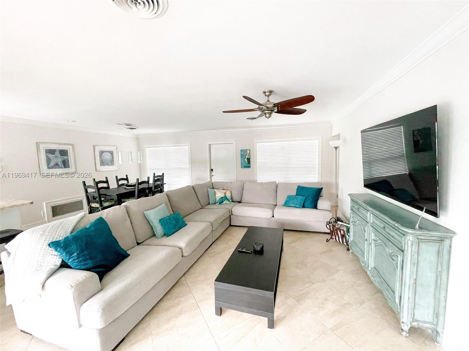 2932 Northeast 36th Street Lighthouse Point, FL 33064 - Photo 2 of 34 a living room with furniture and a flat screen tv
