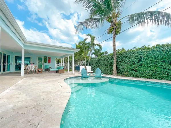 a view of a chair and tables in the patio
