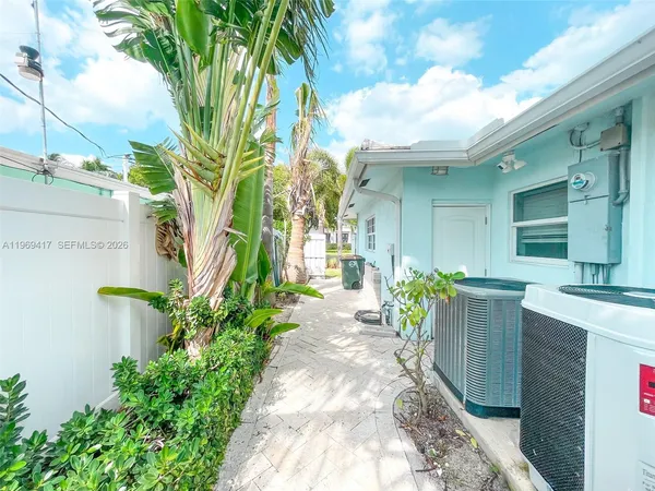 a view of a house with fountain and a potted plant