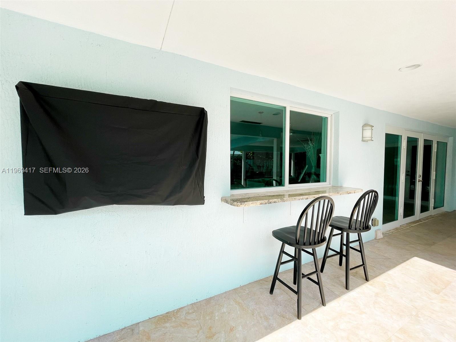 2932 Northeast 36th Street Lighthouse Point, FL 33064 - Photo 30 of 34 a living room with furniture and a flat screen tv