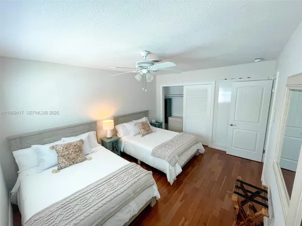 a bedroom with two beds and a chandelier