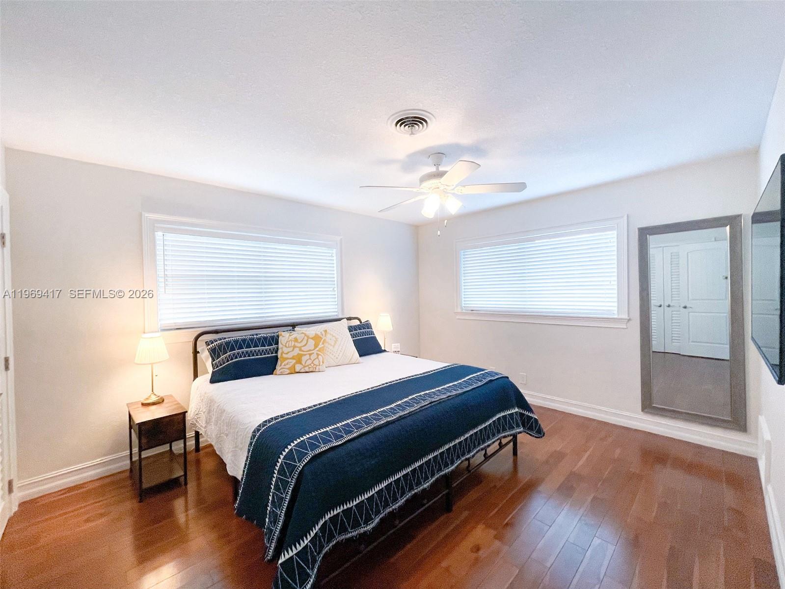 2932 Northeast 36th Street Lighthouse Point, FL 33064 - Photo 10 of 34 a bedroom with a bed and a chandelier