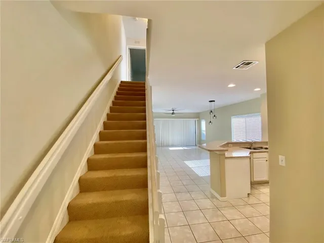 a view of a kitchen with wooden floor and stairs