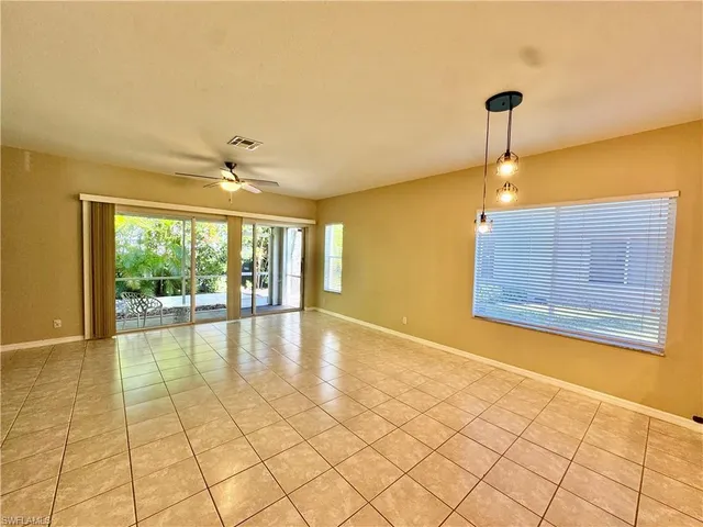 a room with gym equipment and a view of living room