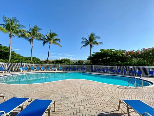a view of a swimming pool with a yard
