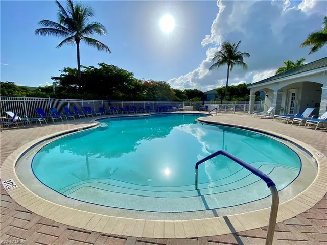 a view of a swimming pool with a lounge chair