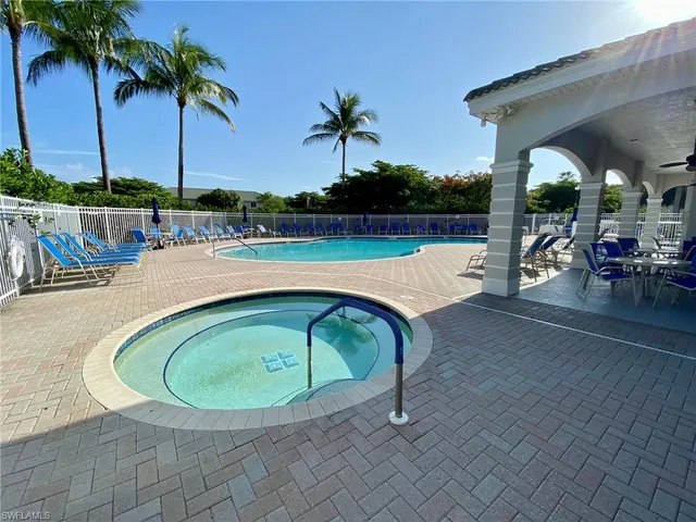 a front view of a house with a tree