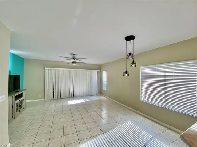 a view of a livingroom with a fireplace and a chandelier