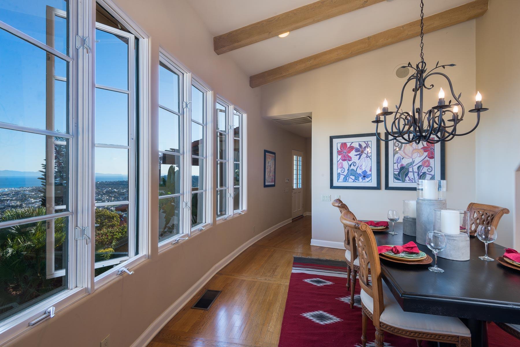 535 Las Alturas Road Santa Barbara, CA 93103 - Photo 7 of 22 a view of a dining room with furniture wooden floor and chandelier