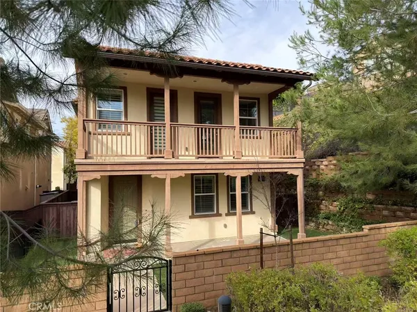 a view of a white house with large windows and a small yard