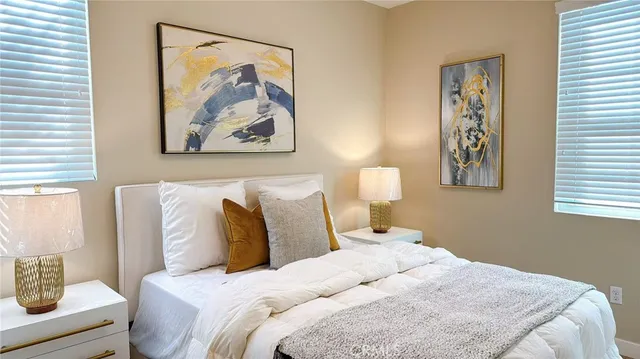 a bedroom with a bed and a painting on the wall
