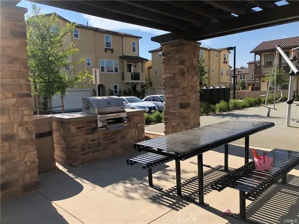 a view of a patio with table and chairs and potted plants