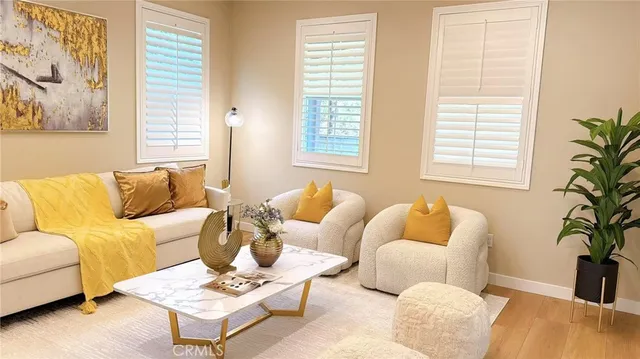 a living room with furniture and a potted plant