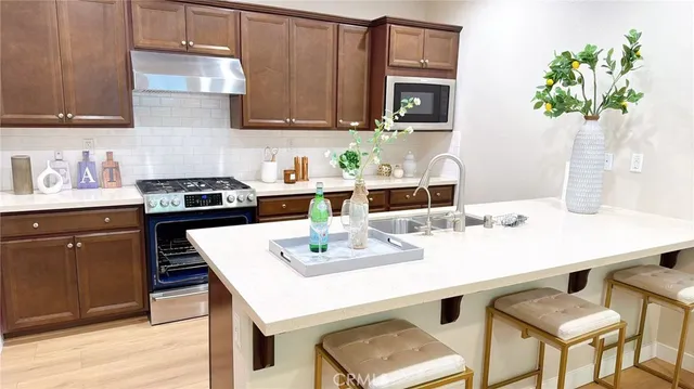 a kitchen with a sink a stove and cabinets
