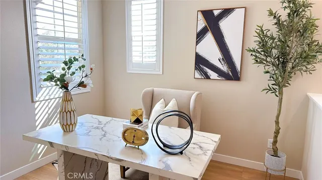 a view of a workspace room with furniture and wooden floor