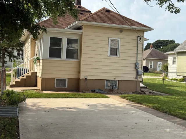 an empty room with a window and a ceiling fan