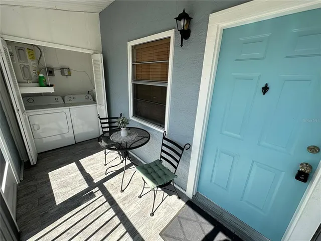 a view of a balcony with furniture